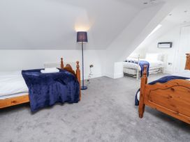 A bedroom with two beds and a lamp at Mount House in Bryniau near Dyserth