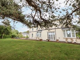 A house with windows and a garden at Mount House in Bryniau near Dyserth