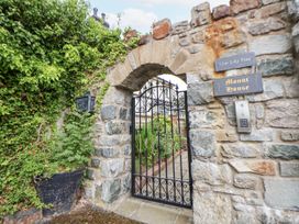 An entrance gate with stone wall and sign at Mount House near Bryniau Dyserth
