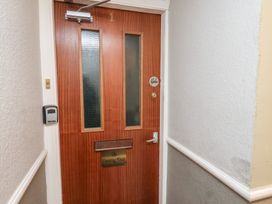 A wooden door with two vertical glass panels and a no smoking sign in a hallway at The Counting House in Bridlington