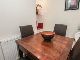 A dining area with a wooden table and brown chairs with a decorative bowl on the table at Counting House in Bridlington