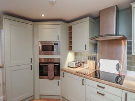 A kitchen with built in microwave oven toaster and cooktop at Secret Garden in Bridlington