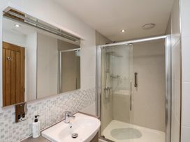 A bathroom with a sink and a glass enclosed shower at Secret Garden in Bridlington