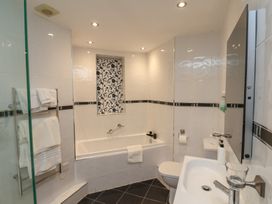 A bathroom with a bathtub toilet sink and towel rack at Lookout Post in Bridlington