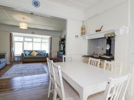 A dining room with a table and chairs at Sea Ledge in Tintagel