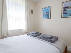 A bedroom with a bed and towels at Sea Ledge in Tintagel
