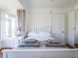A bedroom with a bed and towels on it at Sea Ledge in Tintagel