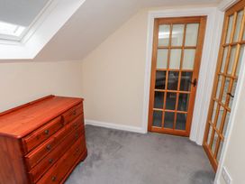 A small room with a wooden chest of drawers a skylight window and two wooden glass-panelled doors at Timberwick Green in Akeld near Wooler