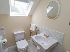 A bathroom with a toilet and sink under a skylight window at Timberwick Green Akeld near Wooler