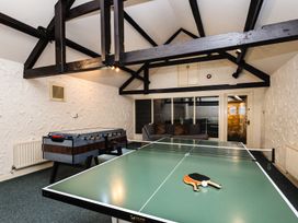 A recreation room with a table tennis table and a foosball table at Timberwick Green Akeld near Wooler