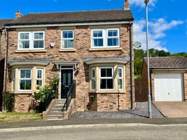 A house with multiple windows and garage at Harefield in Rothbury