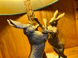 A sculpture of rabbits near a lamp at Harefield in Rothbury