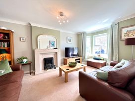 A living room with a fireplace and television at Harefield, Rothbury