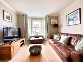 A living room with a television, sofa, and coffee table at Harefield in Rothbury