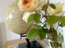 A globe and flowers on a table at Harefield in Rothbury