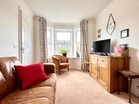 A living room with a sofa and television at Harefield in Rothbury
