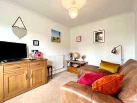 A living room with a sofa and tv at Harefield in Rothbury