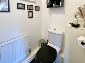 A bathroom with a toilet and shelf at Harefield in Rothbury