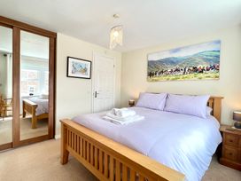 A bedroom with a bed and artwork at Harefield in Rothbury