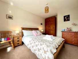 A bedroom with a bed and wooden furniture at Harefield in Rothbury