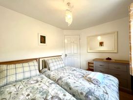 A bedroom with twin beds and a dresser at Harefield in Rothbury