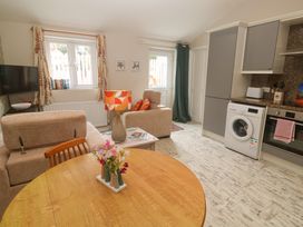 A living room with a sofa and television at The Stable in Rosudgeon