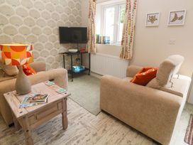 A living room with a television and sofa at The Stable in Rosudgeon