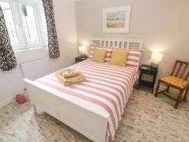 A bedroom with a bed and bedside table at The Stable in Rosudgeon