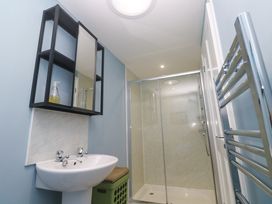 A bathroom featuring a sink, shower, and mirror at The Stable in Rosudgeon