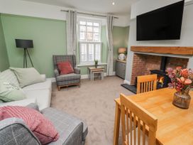 A living room with a sofa and dining table at 3 Lisburn Street Alnwick