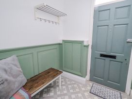 A hallway with a coat rack and bench at 3 Lisburn Street Alnwick