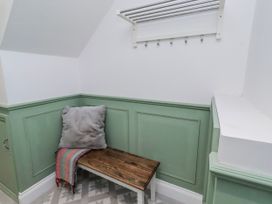 A hallway with a bench and hooks at 3 Lisburn Street Alnwick