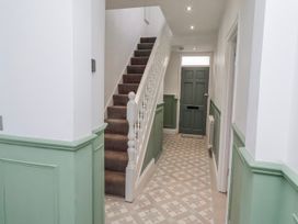 A hallway with a staircase and front door at 3 Lisburn Street in Alnwick