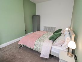 A bedroom with a bed and wardrobe at 3 Lisburn Street Alnwick