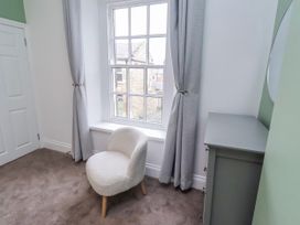A bedroom with a chair and window at 3 Lisburn Street Alnwick