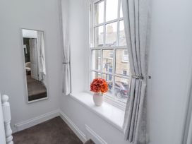A landing with a window and a flower vase at 3 Lisburn Street Alnwick