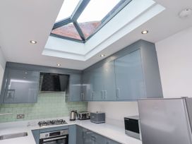 A kitchen with cabinets and appliances at Middle Cottage in Alnwick
