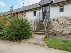 An entrance with steps and a door at Coombe Barn in Cusgarne near St Day