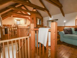 A living room with a sofa and dining table at Coombe Barn Cusgarne near St Day