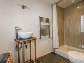 A bathroom with sink and shower at Coombe Barn in Cusgarne near St Day