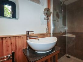 A bathroom with a sink and shower at Stribleys Barn Cusgarne near St Day