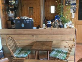 A cafe interior with a counter and seating area at Stribleys Barn in Cusgarne
