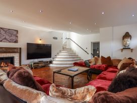 A living room with a sofa and television at Delmonte Lodge in Torquay