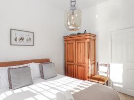 A bedroom with a bed and wardrobe at Delmonte Lodge in Torquay