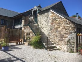 An outdoor view of stairs and a garden bench at Pit Paddy Barn in Cusgarne near St Day