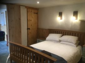 A bedroom with a bed and bedside table at Pit Paddy Barn Cusgarne near St Day