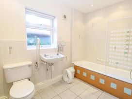 A bathroom with a toilet sink bathtub and window at Swallow Barn in Holton near Halesworth