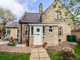 An exterior view of a house showing a door and pathway at The Lodge in Powburn