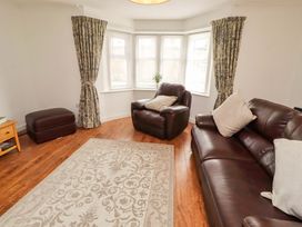 A living room with a sofa and armchair at The Lodge in Powburn
