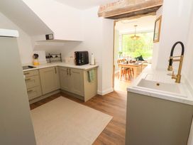 A kitchen with cabinets and a sink at The Lodge in Powburn
